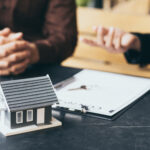 Legal documents and house keys on a desk, symbolizing property transfer through probate in New York.